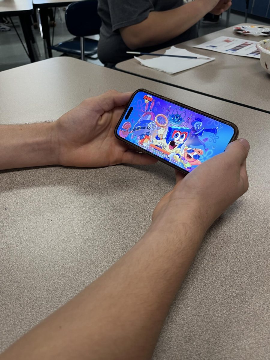 Big Spring senior plays Brawl Stars on his phone. This game is played frequently during free time in school.