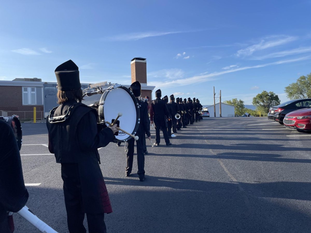 The Marching Bulldogs are lining up to march down to the stadium. They are about to perform at the home football game against Trinity High School. 