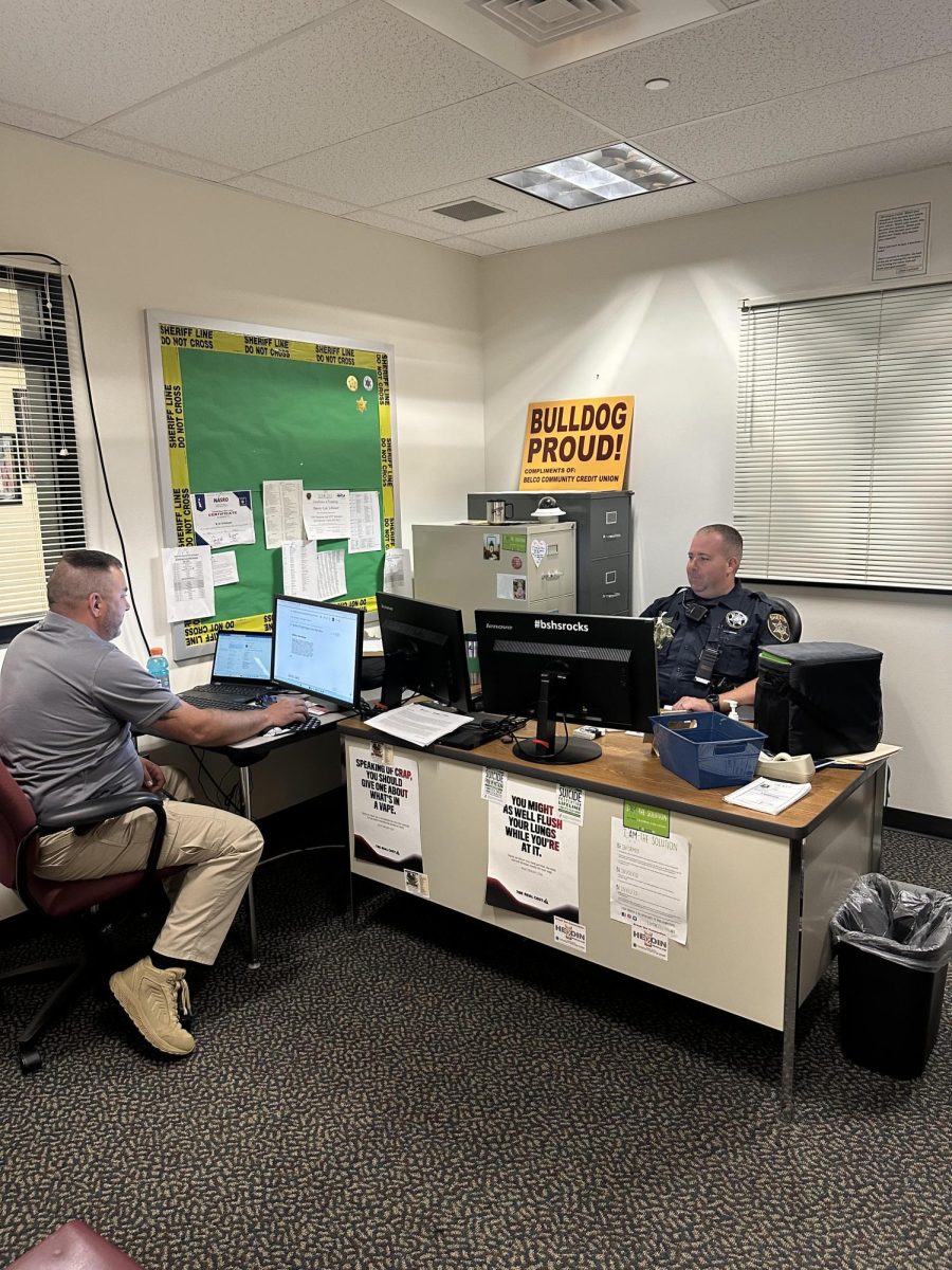 Officers Mike Sturm and Kyle Schlusser discuss their plans for the day. Their offices is right beside the office for extra safety.